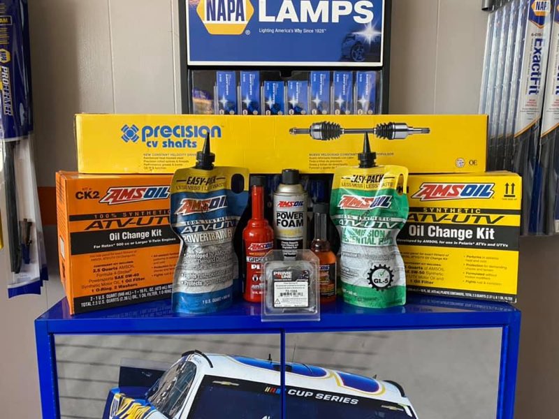 Display of NAPA parts and AMSOIL ATV-UTV oil change kits on the shop counter